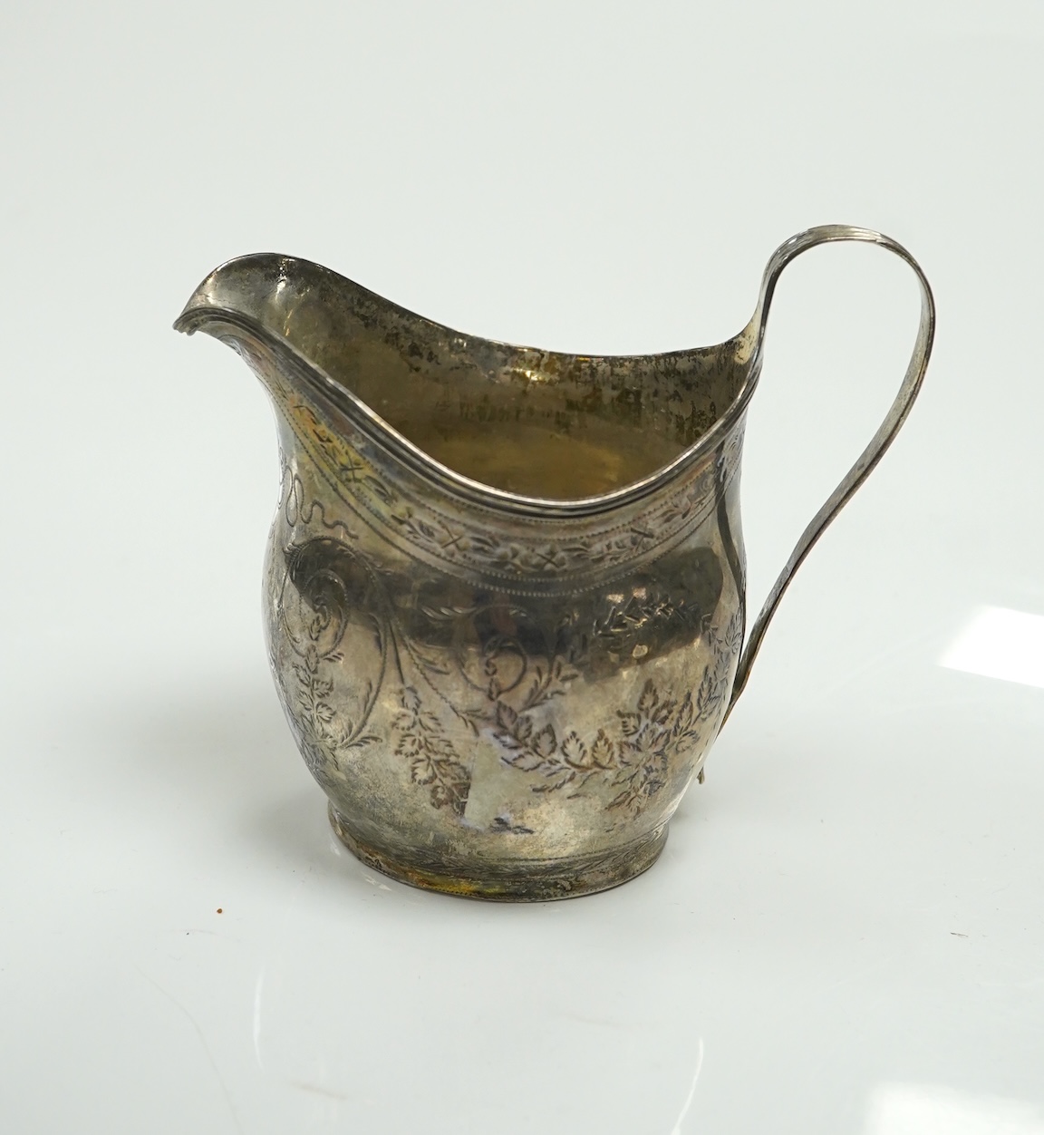 Two George III silver cream jugs, Sheffield, 1805 and London, 1808, largest 11cm. Condition - poor